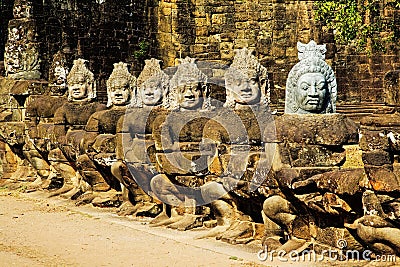 Row of asuras, or demons, at Angkor Thom Cambodia Stock Photo