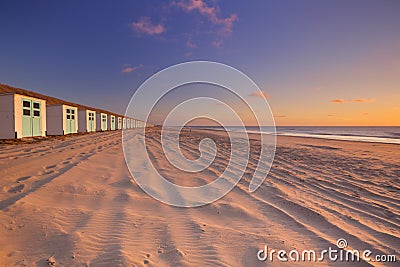 Row of beach huts at sunset, Texel, The Netherlands Stock Photo