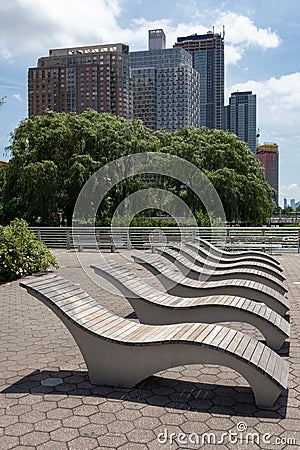 A Row of Empty Modern Wood Recliners at Gantry Plaza State Park in Long Island City Queens New York during Summer Stock Photo