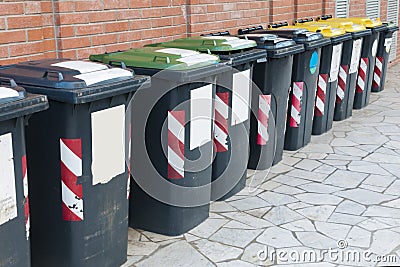 Row of bins for the separate collection of glass, paper and aluminum Stock Photo