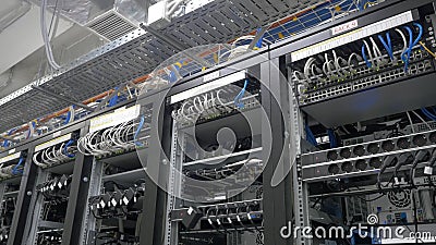 Device for mining crypto currency. Row of bitcoin miners set up on the wired shelfs. Mining cryptocurrency. Bitcoin farm Stock Photo