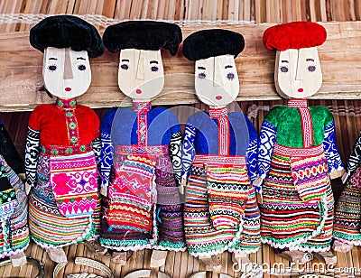 Row of black and red Dzao wooden dolls Stock Photo