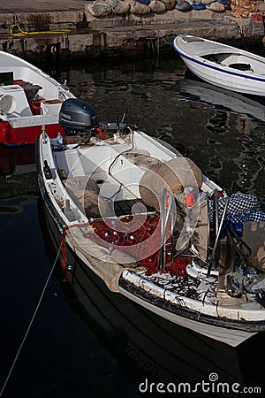 a row boat with netting hanging out of the deck, filled with lobsters Editorial Stock Photo