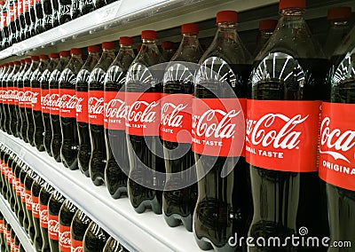 Row of bottles of Coca-Cola original taste on a shelf in a store Editorial Stock Photo