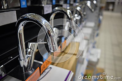 Row of brand new chrome colored water faucets Stock Photo