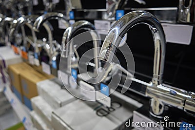 Row of brand new chrome colored water faucets Stock Photo