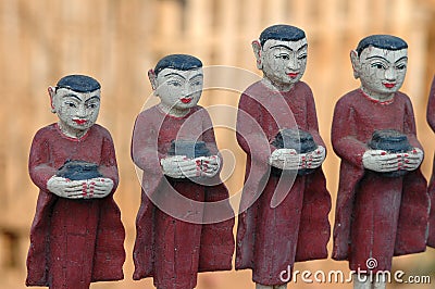 Row of buddhist monks with alms bowls Stock Photo