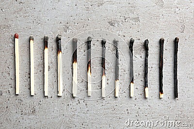 Row of burnt matches and whole one, flat lay. Human life phases concept Stock Photo