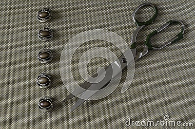 Row of buttons and old scissors on the table Stock Photo