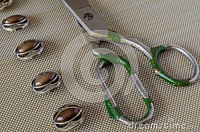Row of buttons and old scissors on the table Stock Photo