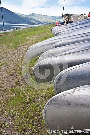 Row of Canoes at Summer Camp Stock Photo