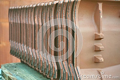 Row of clay roof tiles, prepared for its insertion on the construction site Stock Photo