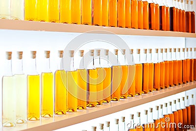 A row of colored bottles with cognac Stock Photo