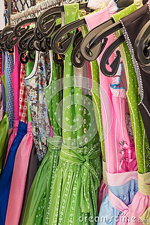 Row of colorful austrain and bavarian dirndl dresses hanging on Stock Photo