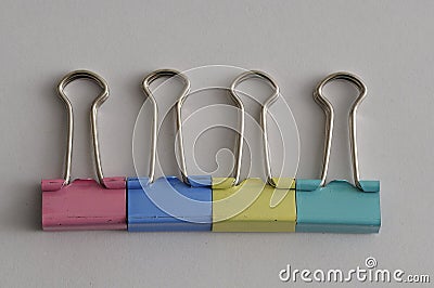 A row of colorful binder clips Stock Photo