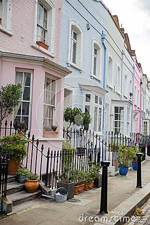 Row of colorful British houses with handrails and plants Stock Photo