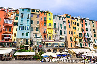 Row of colorful multicolored buildings houses and restaurants of Portovenere coastal town village in harbor of Ligurian sea, Rivie Editorial Stock Photo