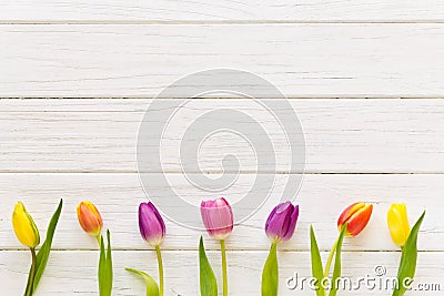 Row of colorful tulips on a wooden background in spring Stock Photo