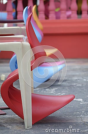 Row of colourful plastic chairs Stock Photo