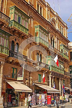 A row of commercial souvenir gift shop shops selling souvenirs with Maltese flags at Melita Street St, Valletta, Malta Editorial Stock Photo