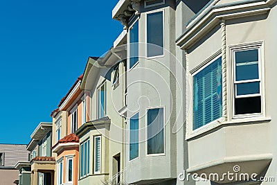 Row of decorative house facades or home exteriors in historic districts of San Francisco California neighborhood Stock Photo