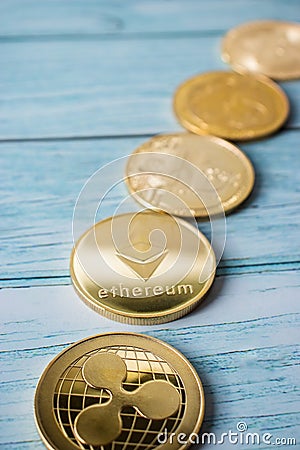 Row of different cryptocurrency coins in close-up, Ethereum, Xrp, Bitcoin Editorial Stock Photo