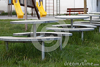 Row of empty outdoor tables and benches Stock Photo