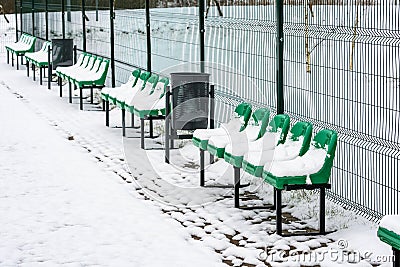 The row of empty plastic green seats at sports ground Stock Photo
