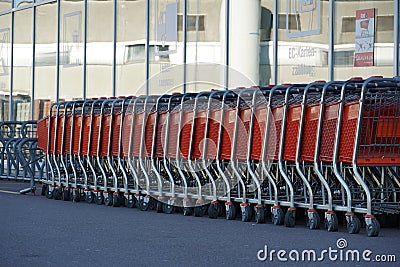 A row of empty trolleys and empty bike rack in front of closed store Editorial Stock Photo