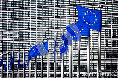 Row of EU Flags in front of the European Union Commission building in Brussels. Belgium - July 30, 2014 Stock Photo