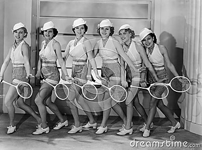 Row of female tennis players in matching outfits Stock Photo