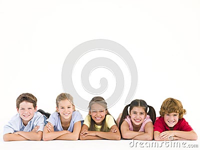 Row of five friends lying down smiling Stock Photo