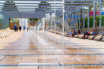 Row of fountains in a park at a high shutter speed freezing the motion of the water and suspended droplets with variety of shape, Stock Photo