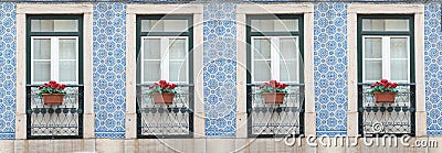 Row with four lattice windows and flower pots, facade with azulejos tiles Stock Photo