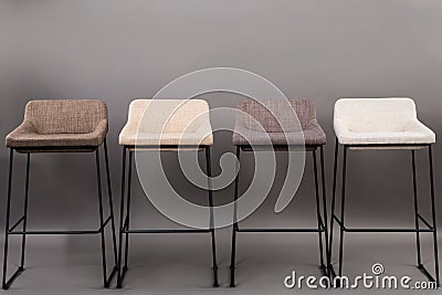 Row of four modern bar chairs isolated on gray background. Furniture series. Stock Photo