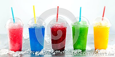 Row of Frozen Fruit Slushies in Plastic Cups Stock Photo