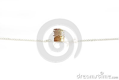 Row of golden coins is sustained balancing on nearly absent rope Stock Photo