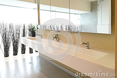 Row of hand washing sinks in modern public toilet Stock Photo