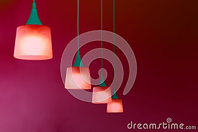 Row of hanging lamp in red green glowing neon color Stock Photo