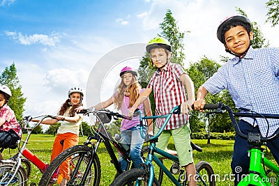 Row of happy children in bike colorful helmets Stock Photo