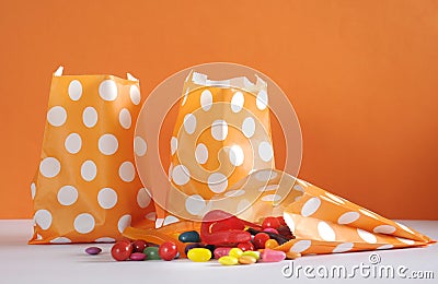 Row of Happy Halloween orange polka dot trick or treat paper bags Stock Photo