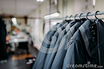 Row of jackets on hangers, clothing store, fabric Stock Photo