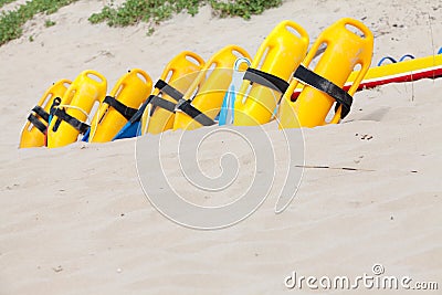 Row of lifesaving floation devices on the beach Stock Photo
