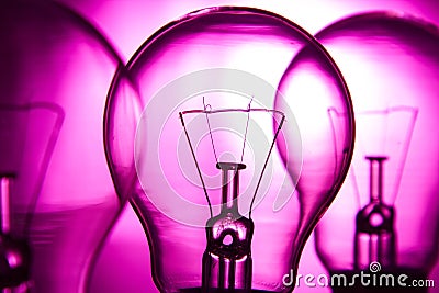 Row of light bulbs on a bright pink background Stock Photo