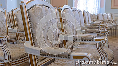 Row of luxury vintage chairs. Chairs for seating the audience at the conference or concert. Theatrical armchairs. Stock Photo