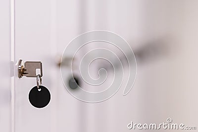 Row of metal lockers with locks, keys and black tags in a sports changing room for securing personal Stock Photo
