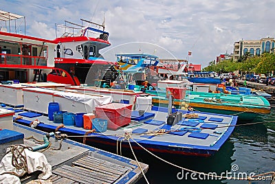 A row of modern large fishing vessel boat boats docking along Boduthakurufaanu Magu nearby the fish market at Male Maldives Editorial Stock Photo