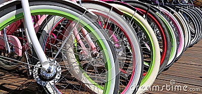 Row multicolored bicycle wheels closeup Stock Photo