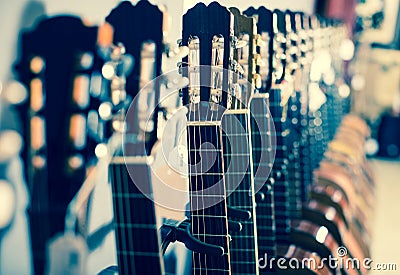 Row of new acoustic guitars in music shop Stock Photo