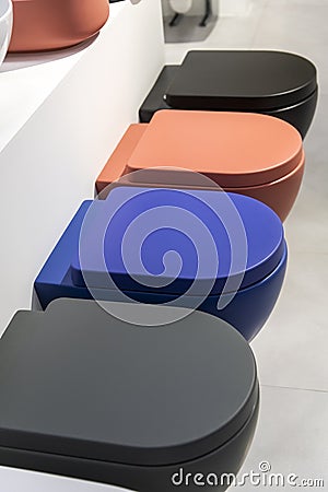 A row of new colored toilet bowls Stock Photo